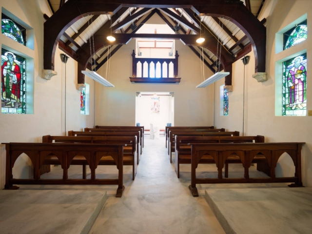 St Oswald Church Historic interior of Saint Oswald's Memorial Church showing wooden pews, stained glass windows, and vaulted timber ceiling - intimate heritage wedding chapel venue