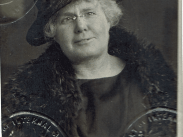 Historic portrait of elderly woman in ornate hat and fur collar against decorative architectural backdrop, heritage church setting