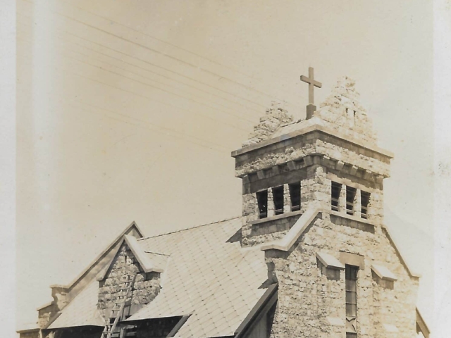 Historic stone memorial church with bell tower and cross, ideal for intimate heritage wedding ceremonies and chapel events.